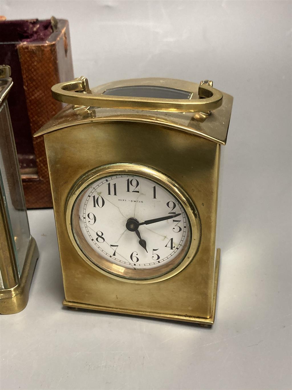 Three small gilt brass carriage timepieces, one with leather outer case, largest 10.5cm high